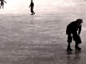 boys skating frozen lake